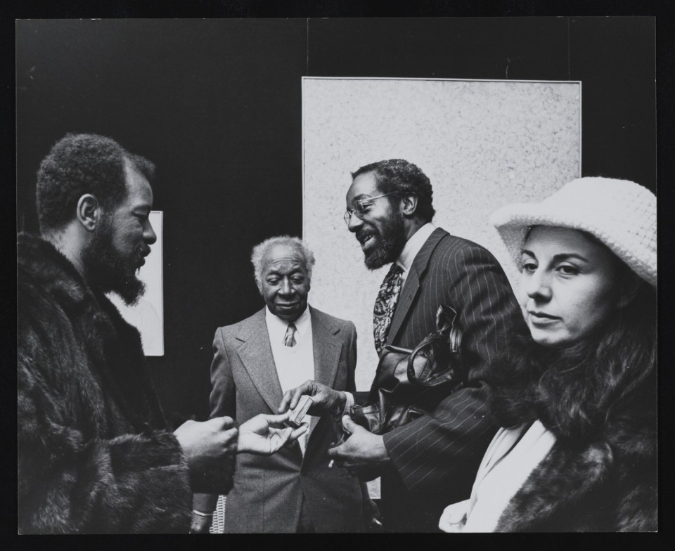 Ornette Coleman (left) attends a Smithsonian Institution exhibition by painter Beauford Delaney (center-left) in 1973. (Unidentified photographer. Galerie Darthea Speyer records, 1953-2010. Archives of American Art, Smithsonian Institution.)